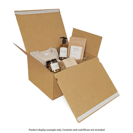 Open cardboard box with various items including a bottle, jar, and package on a white background.