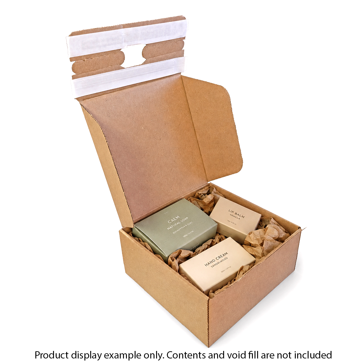 Open cardboard box with bath products on a white background