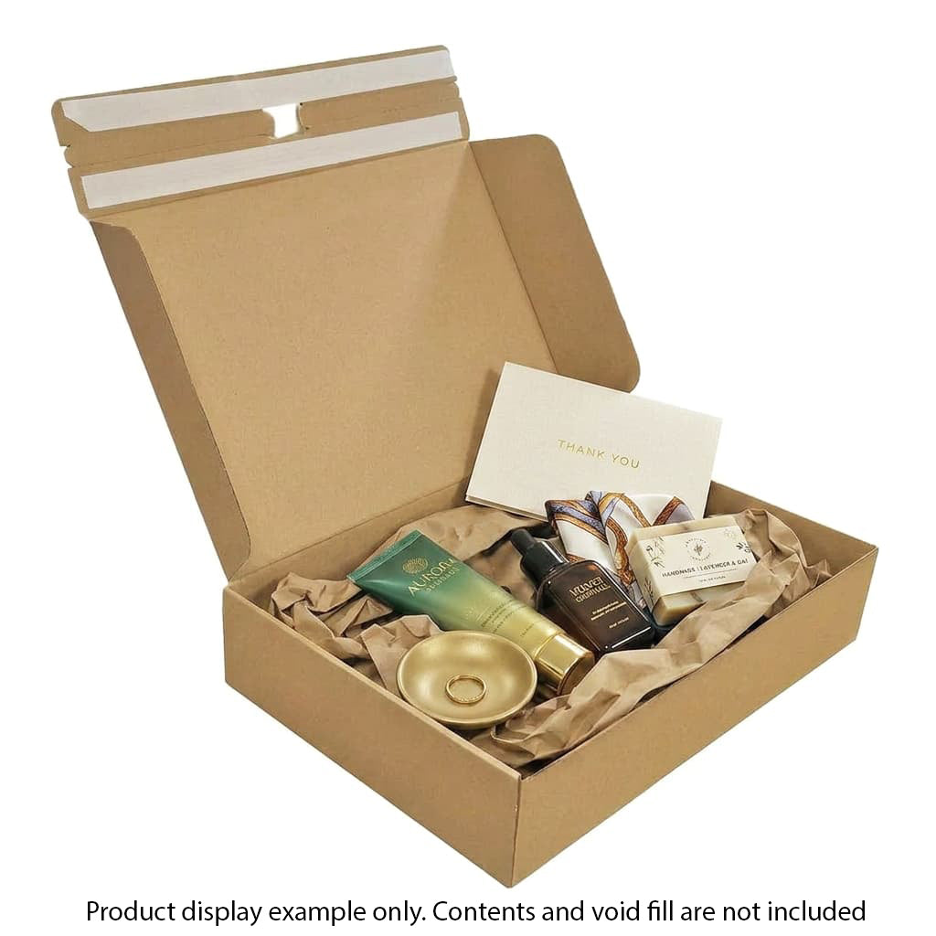 Open cardboard box with various items including a bowl, bottles, and a card inside.